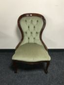 A lady's chair upholstered in green button dralon