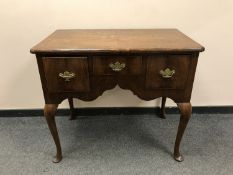 A George III three drawer walnut lowboy,