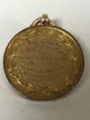 A 9ct gold disc fob presented to Lieut J D Milburn for valour in the Great War, 8.5g.