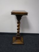 An early 20th century oak barley twist column plant stand