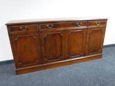 An inlaid mahogany four door sideboard