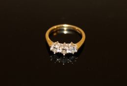 An 18ct gold three stone diamond ring,