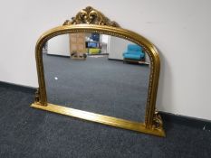 A gilt framed Victorian style overmantel mirror