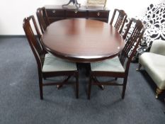 A Stag Minstrel circular extending table and four chairs