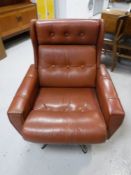 A Danish brown button leather armchair on a chrome base