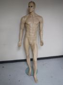 A shop mannequin on brass stand