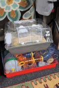 Two hamster cages together with a quantity of accessories