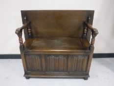 An oak linen fold monk's bench