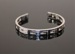 An 18ct gold diamond set bangle by Gucci, 28.
