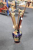 A china vase containing various canes and walking sticks