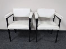 A pair of mid 20th century white vinyl upholstered metal framed armchairs
