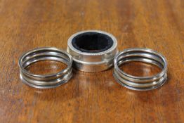 A pair of silver napkin rings together with one other sterling silver napkin ring (3)
