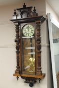 A Victorian wall clock with enamelled dial,