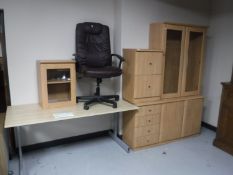 A computer desk with high back armchair,