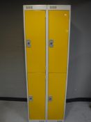 A metal four door locker (two doors with keys)