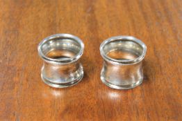 A near pair of silver napkin rings, Birmingham 1916 / 1918.