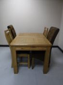 A contemporary oak extending table with two leaves and pair of rail back chairs and pair of brown