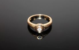 An 18ct gold ring set with a .15 solitaire diamond, 4.