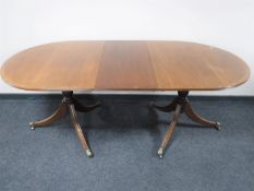 A Regency style twin pedestal table with leaf
