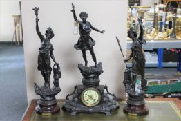 A three piece French spelter clock garniture