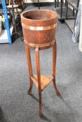 An oak jardiniere on stand