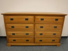 A contemporary pine eight drawer chest,