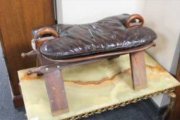 A 20th century camel stool with button leather cushion
