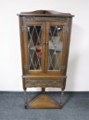 An oak Old Charm double door corner cabinet