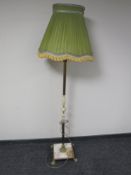 A brass and onyx standard lamp with shade on paw feet
