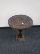 A carved hardwood Eastern occasional table on a pine base