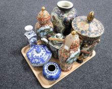 A tray of oriental wares to include lidded jar, vases, teapot,