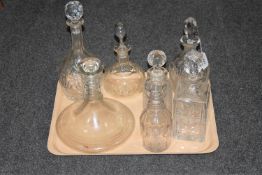 A tray of seven glass decanters with stoppers