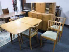 A mid 20th century six piece teak dining room suite