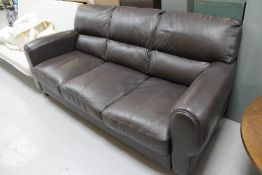 A brown leather three seater settee
