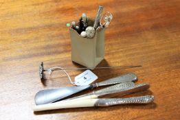 A small pot containing silver handled button hook and shoe horn, glove stretchers,