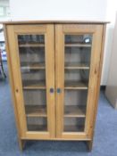 A pine glazed door bookcase