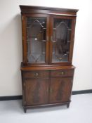 A mahogany bookcase fitted cupboards beneath