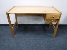A contemporary pine desk fitted two drawers