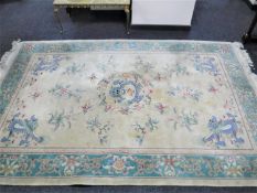 A fringed Chinese rug of dragon design on yellow ground