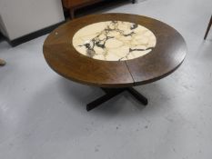 A circular oak coffee table inset with a marble panel