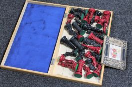 A stained resin chess set and board together with a children's volume;