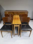 A mid 20th century six piece dining room suite in a walnut finish
