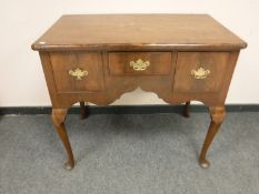 A George III walnut three drawer low boy,