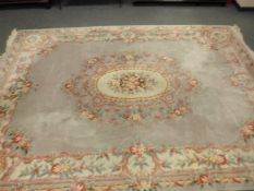 A Chinese floral carpet on mauve ground,