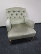 An early 20th century armchair in green dralon