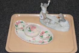 A Spanish figure of a girl and boy on seesaw,