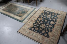 A fringed Chinese rug with dragon decoration on green ground and one other