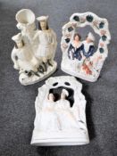 A pair of Staffordshire flat backed figures - Figures seated on a bench together with a