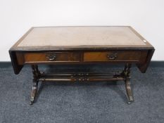 A mahogany leather topped sofa table