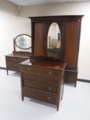 A three piece Victorian inlaid mahogany bedroom suite comprising of mirror door wardrobe,